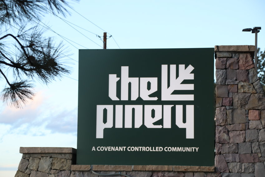 A sign marks The Pinery residential area along state Highway 83 south of the Town of Parker.